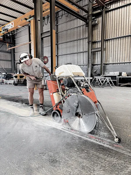 A licensed specialist demonstrating different concrete cutting methods in a Perth, WA demolition work, specifically floor sawing